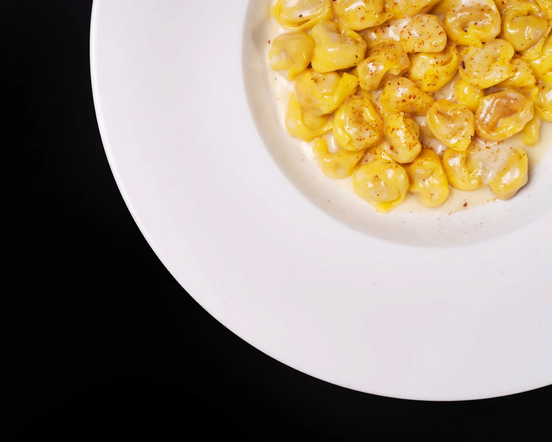 A serving of handmade pasta is arranged in close-up.